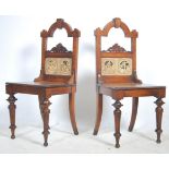 A Pair of Victorian oak hall chairs raised on turn
