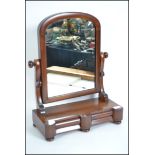 A Victorian mahogany toilet swing mirror having tw