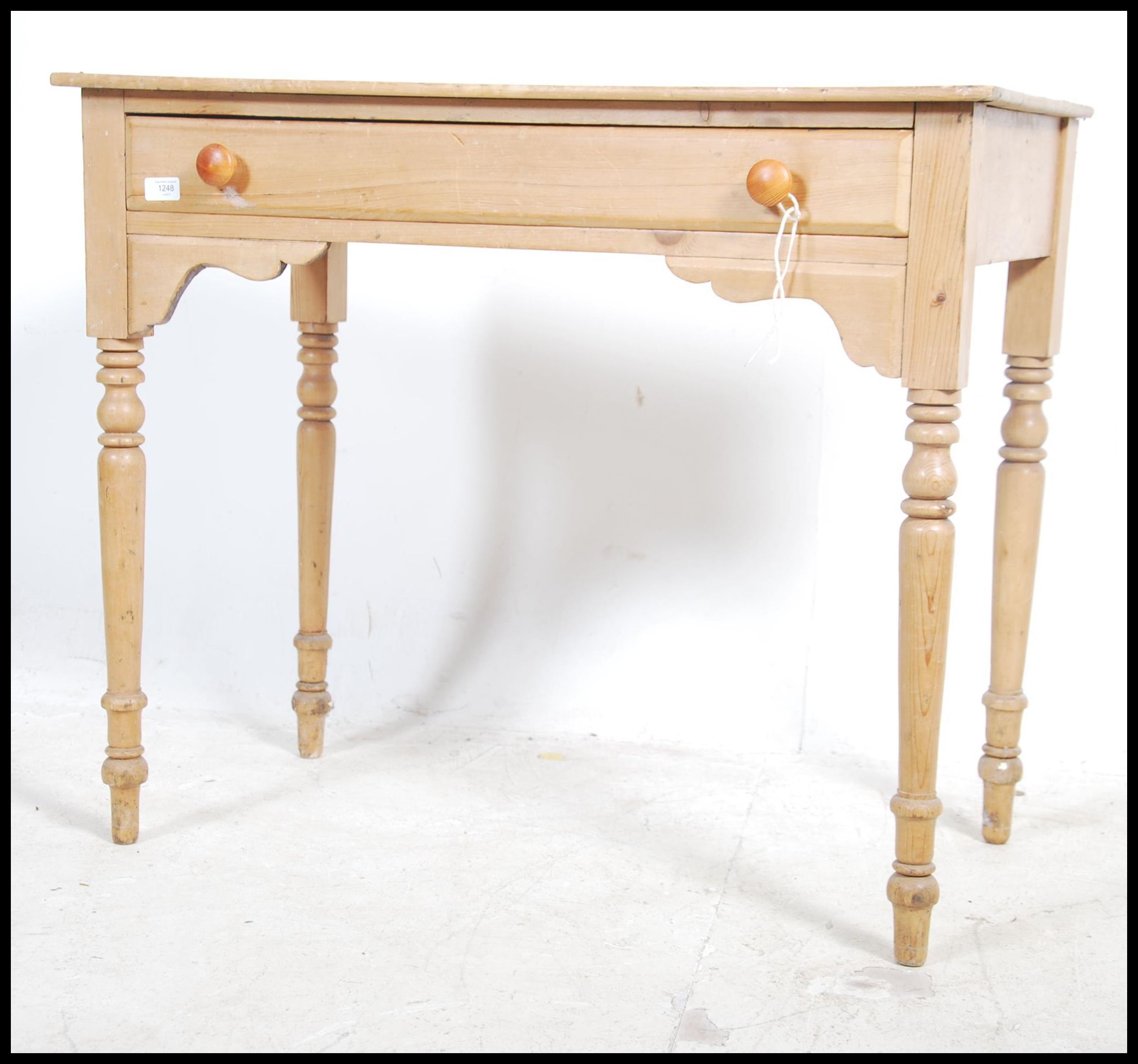 A Victorian country pine writing table being raise