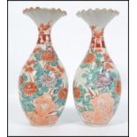 A pair of early 20th century Chinese baluster vases with fluted tops, decorated with foliate