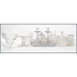 A collection of cut glass to include a dressing table set, candlesticks, cake stand, various vials