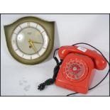 A retro 20th century red ring dial telephone toget