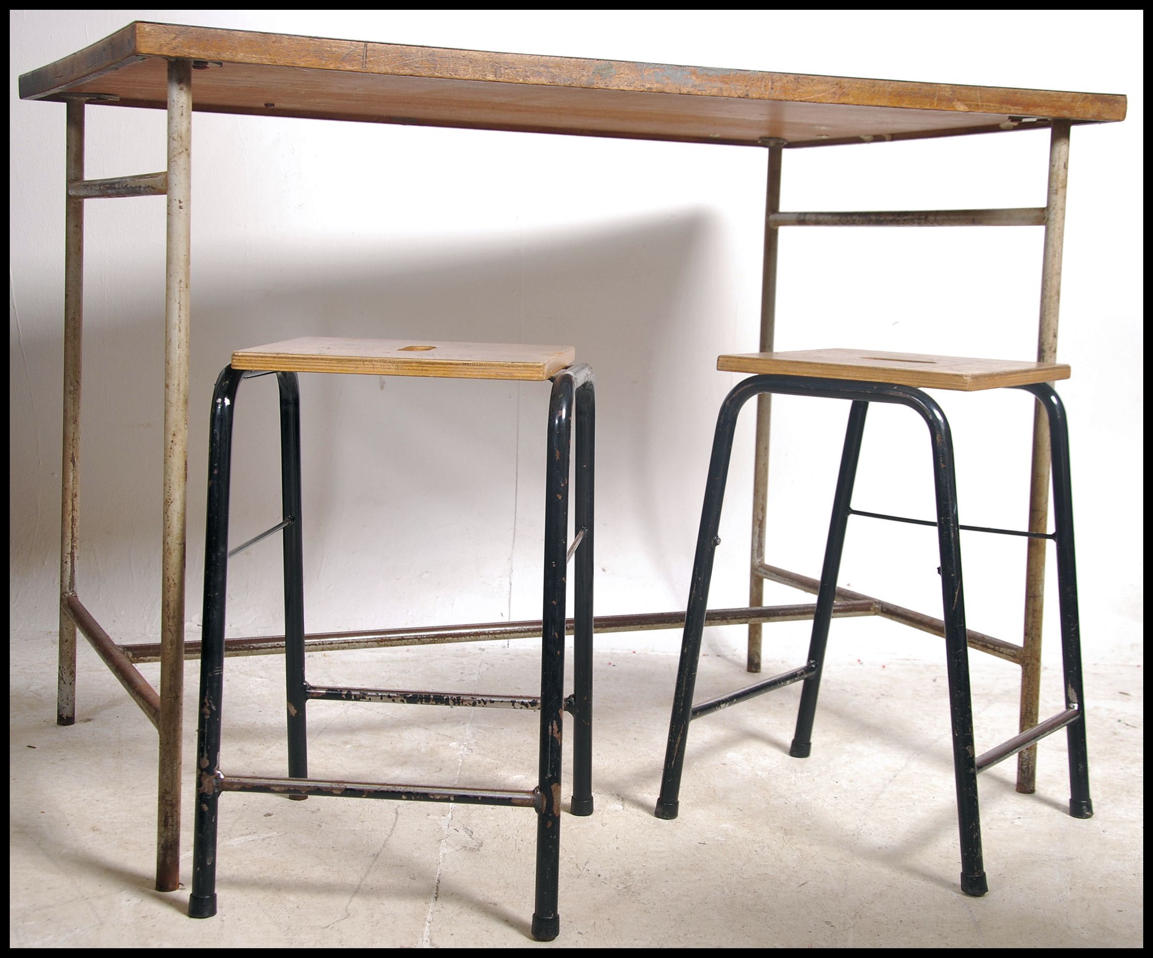 A mid century tubular metal School laboratory desk