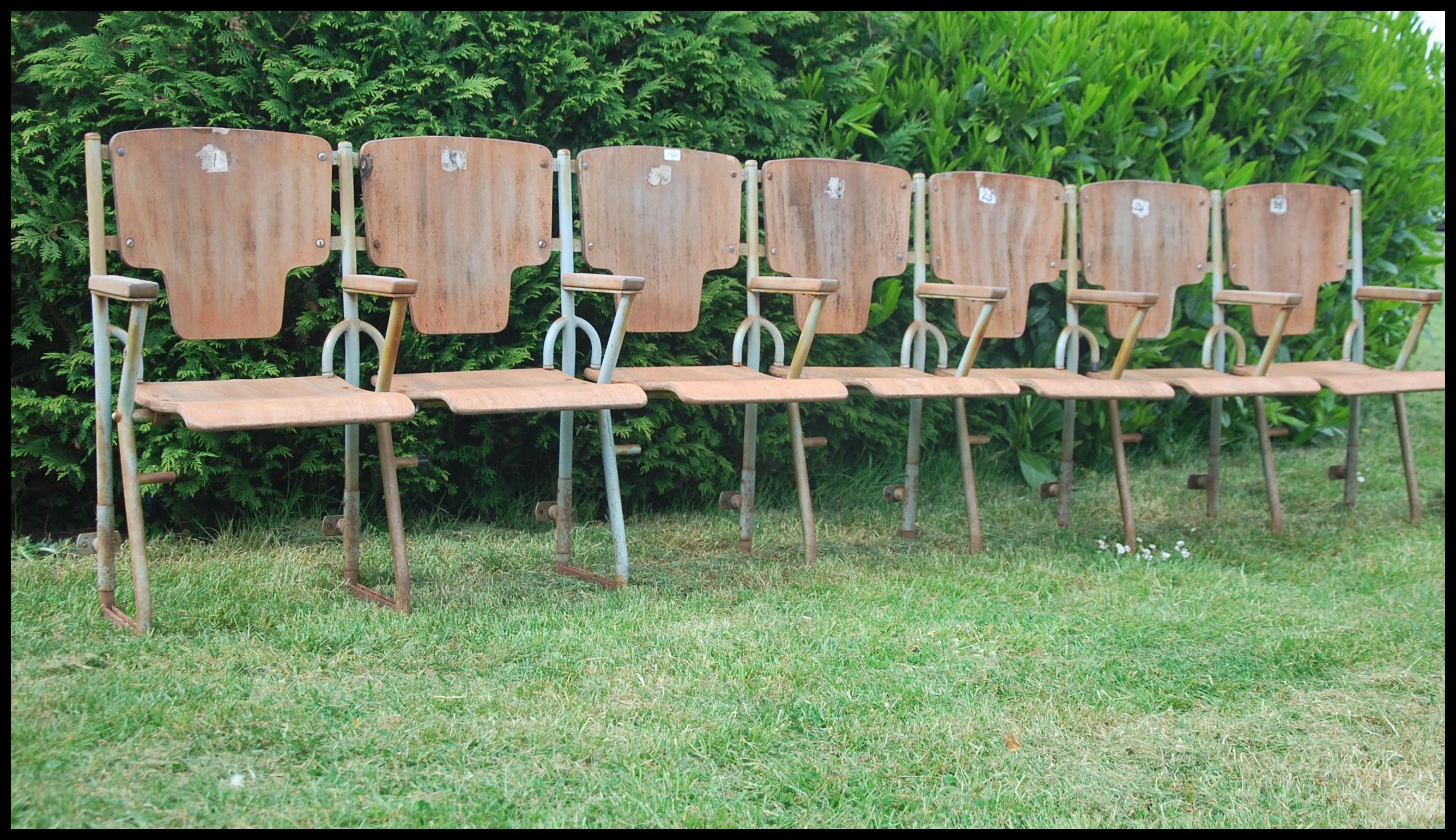 A set of four vintage 20th century cinema chairs.