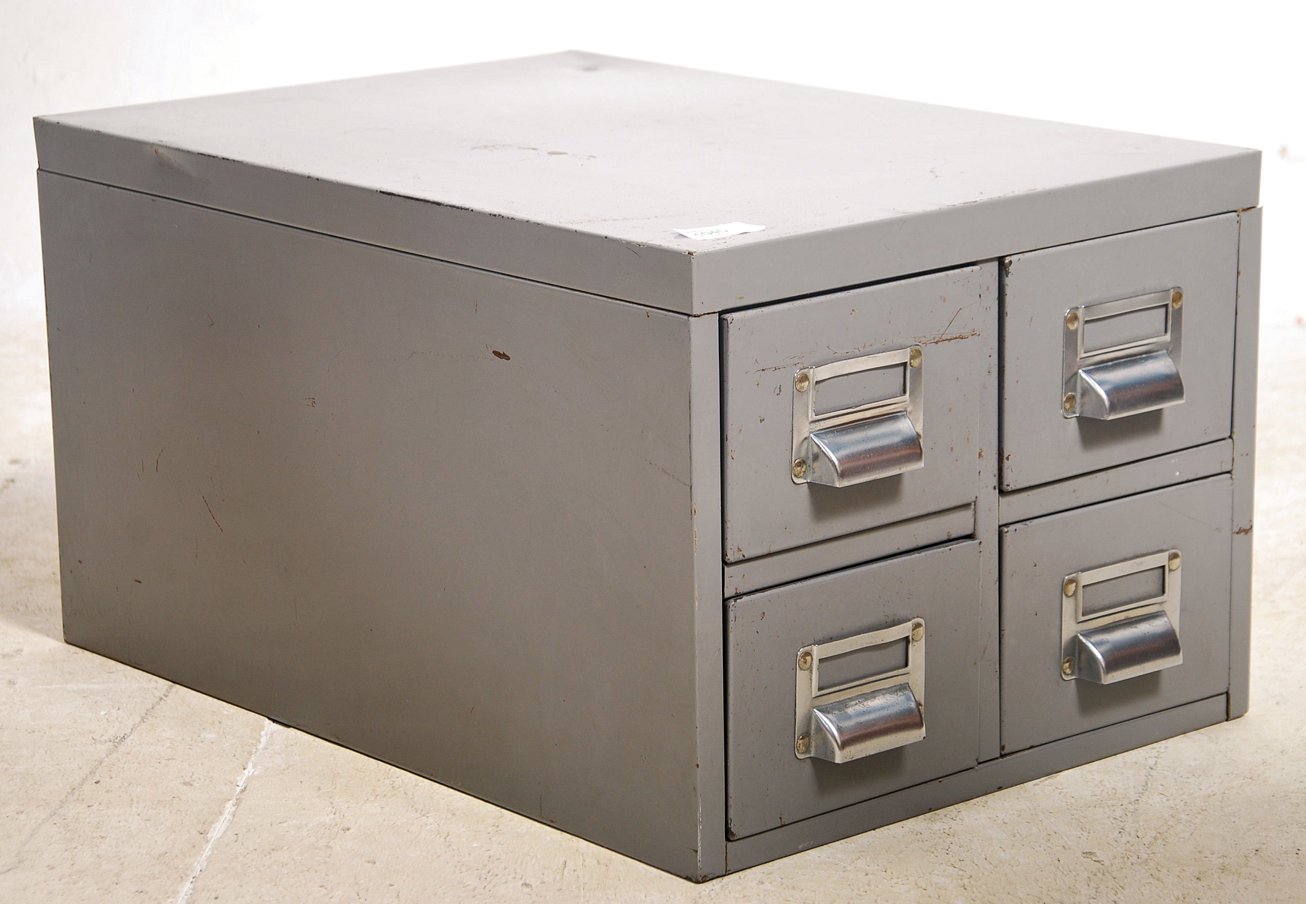 A vintage 20th century industrial heavy grey steel filing cabinet set with four drawers.