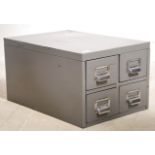 A vintage 20th century industrial heavy grey steel filing cabinet set with four drawers.