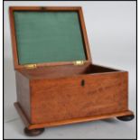 A 19th century Regency satinwood ladies workbox of sarcophagus form. Of exquisite satin wood panel