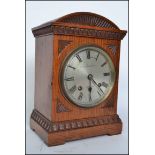 An Edwardian oak cased bracket clock by Courlander of Croydon London. The silvered dial with roman