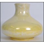 An early 20th century Moorcroft bulbous baluster vase of squat form having a yellow lustre finish.