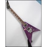 A vintage style 6 string electric axe shaped 5 way guitar having a shaped body with sloped mother of