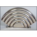 A 1930's Art Deco silver plated WMF type letter rack of arched shell form being stamped to the