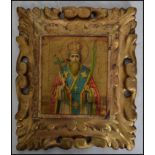 An early 20th century religious Icon, believed Russian with central figure on panel with gilt