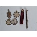 A group of silver hallmarked fobs, a silver pusher pencil and a masonic agate stick pin brooch,