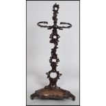 A vintage 20th century cast iron Coalbrokedale style stick / umbrella stand having a painted