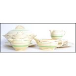 A vintage 20th century Clarice Cliff dinner service consisting of tureen, plates and side plates,