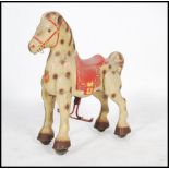 A vintage 20th century Mojo Bronco children's tin plate pedal car type toy horse having painted