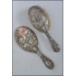 A good silver hallmarked matching ladies clothes brush and hand mirror. The silver to each of