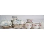 A good group of china ceramic chintzy pattern trios and part tea services to include cups,