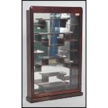 A 20th century Chinese hardwood wall mounted display cabinet, the glazed panel door opening to
