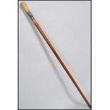 A 19th century ivory handled malacca walking stick cane having a silver collar depicting an oak tree