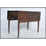 A 19th Century mahogany pembroke table, with frieze drawer and dummy drawer, brass ring handles on