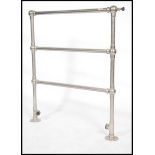 Architectural Salvage. An early 20th century towel radiator. Of tubular form with floor brackets and