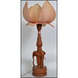 A  mid century Chinese lotus flower lamp having carved hardwood base in the form of elephants having