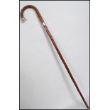 A silver collar blackthorn walking stick hacing a crook handle with tapering stem. Hallmarks for