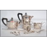 A four piece Sheffield silver plate tea service having ebonised handles along with a collection of