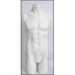 A vintage 20th century shop advertising / point of sale display male torso mannequin in white.