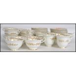 A vintage 20th century bone China tea service decorated with hand applied gilt overlay, consisting