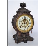 An ornate 19th century cast metal  Ansonia sculptural mantel clock, the movement with revealed
