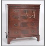 A Mahogany Georgian style bow front bachelors chest of drawers having four long drawers chest with