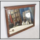A large Victorian oak overmantel mirror. The reeded frame with large bevelled glass plate mirror
