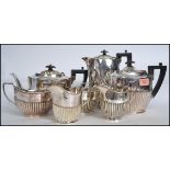 An early 20th century silver plate 4 piece tea and coffee service by Levesley Brothers comprising