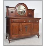An Edwardian large mahogany mirror back sideboard being raised on shaped legs with cupboards and
