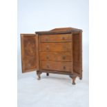 A 1930's oak estate cabinet chest of drawers. The cabinet with twin doors housing a series of