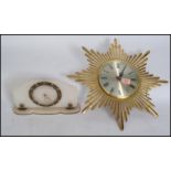 A vintage retro 20th century star burst / sun burst wall clock having faceted hands along with an