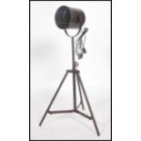 A vintage retro industrial style metal tubular tripod floor  spot lamp, having an adjustable tubular