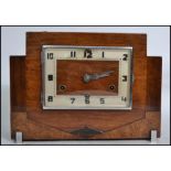 A 1920s Art Deco mantel clock with square face having an Arabic numeral dial enclosing three train