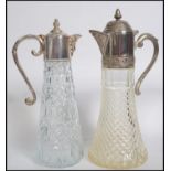 Two vintage early 20th century lead cut glass claret jugs having silver plated tops and lids.