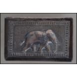 A Siam silver matchbox holder cast in relief with scenes of elephant, plain cartouche to verso.