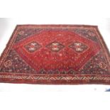 A large Persian floor rug with geometric patterns