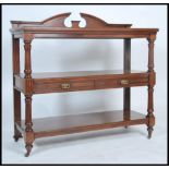 A 19th century Victorian mahogany 3 tier buffet sideboard. Raised on brown ceramic castors with
