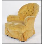 A Victorian Howard style mahogany armchair being button backed with yellow skirt and yellow velour
