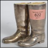 A pair of vintage 20th century silver plated drinks measures in the form of riding boots having