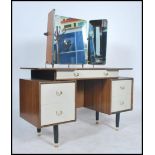 A 1960's retro G-Plan Chinese white and tola wood dressing table having triple mirrors over a