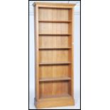 A large contemporary solid oak ( oak furniture land style) open window tall bookcase being raised on