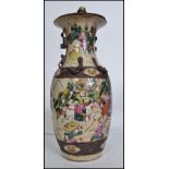 A large 20th century Chinese famille rose baluster vase being converted to a table lamp. The vase
