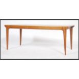 A good Danish 1970's retro rectangular coffee table raised on rounded edge tapering legs with good